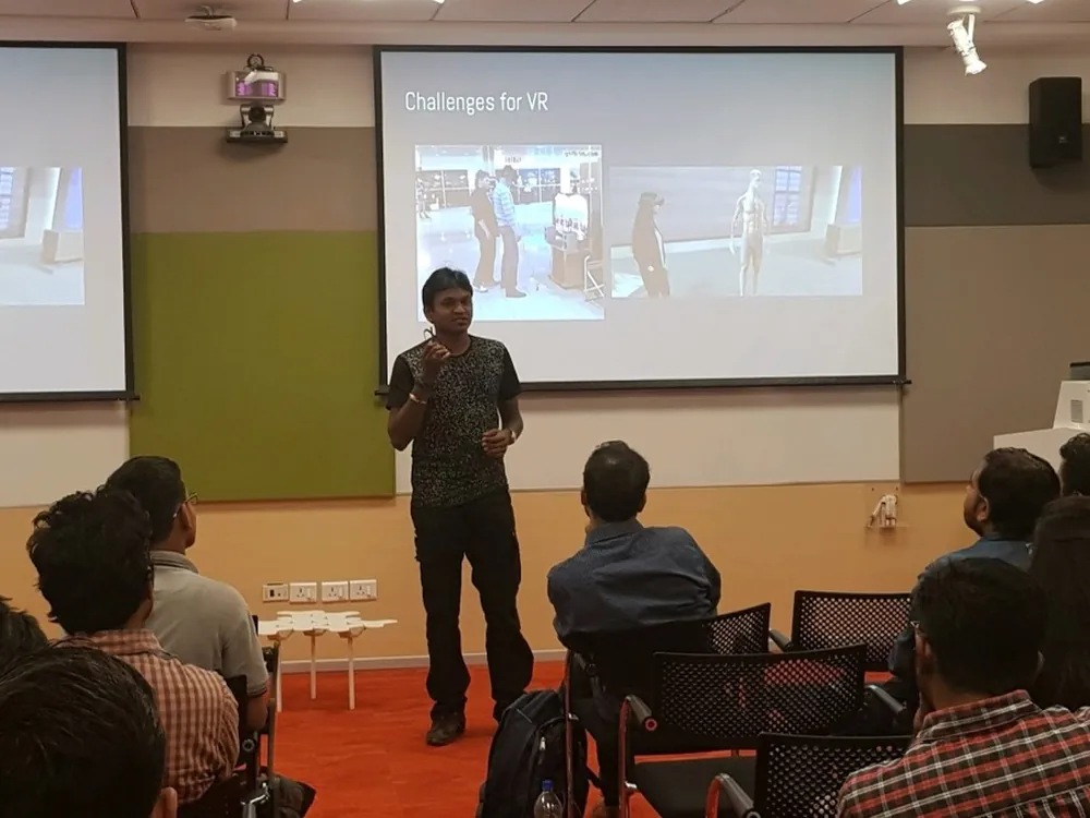 Karthikeyan NG speaking at an event in a Google office.